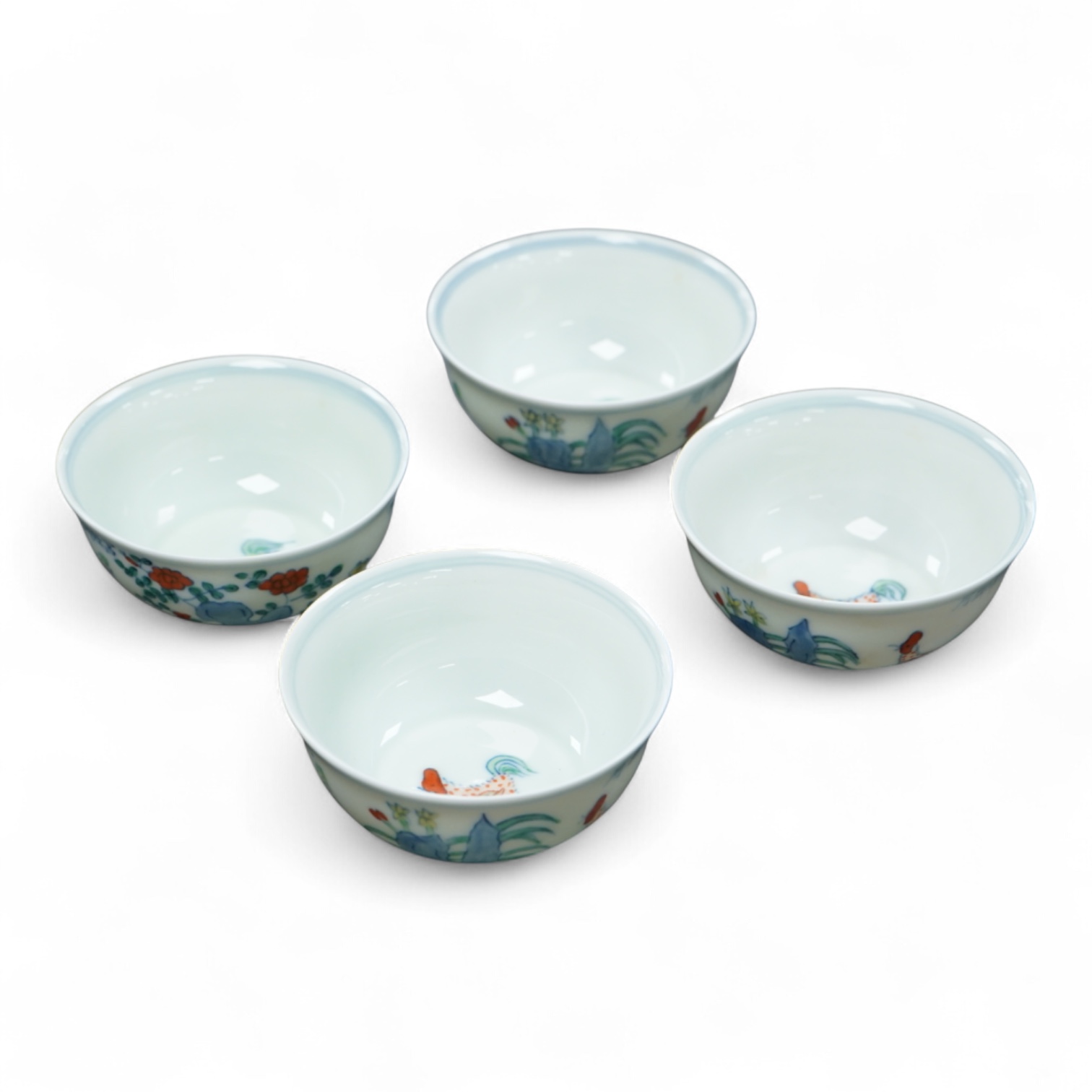 Four Chinese porcelain Wucai tea bowls, 8cm in diameter
